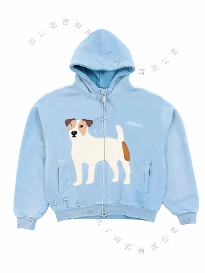 A pale blue zip-up hoodie printed with a small dog, laid flat on white