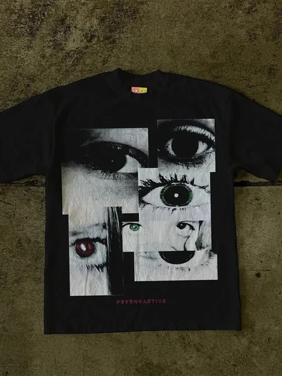 A black tee printed with a large monochrome collage of an eye and torn paper